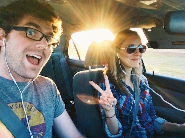 Man and woman in a car during sunset.