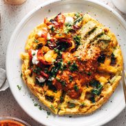 Loaded egg waffle on a plate with toppings