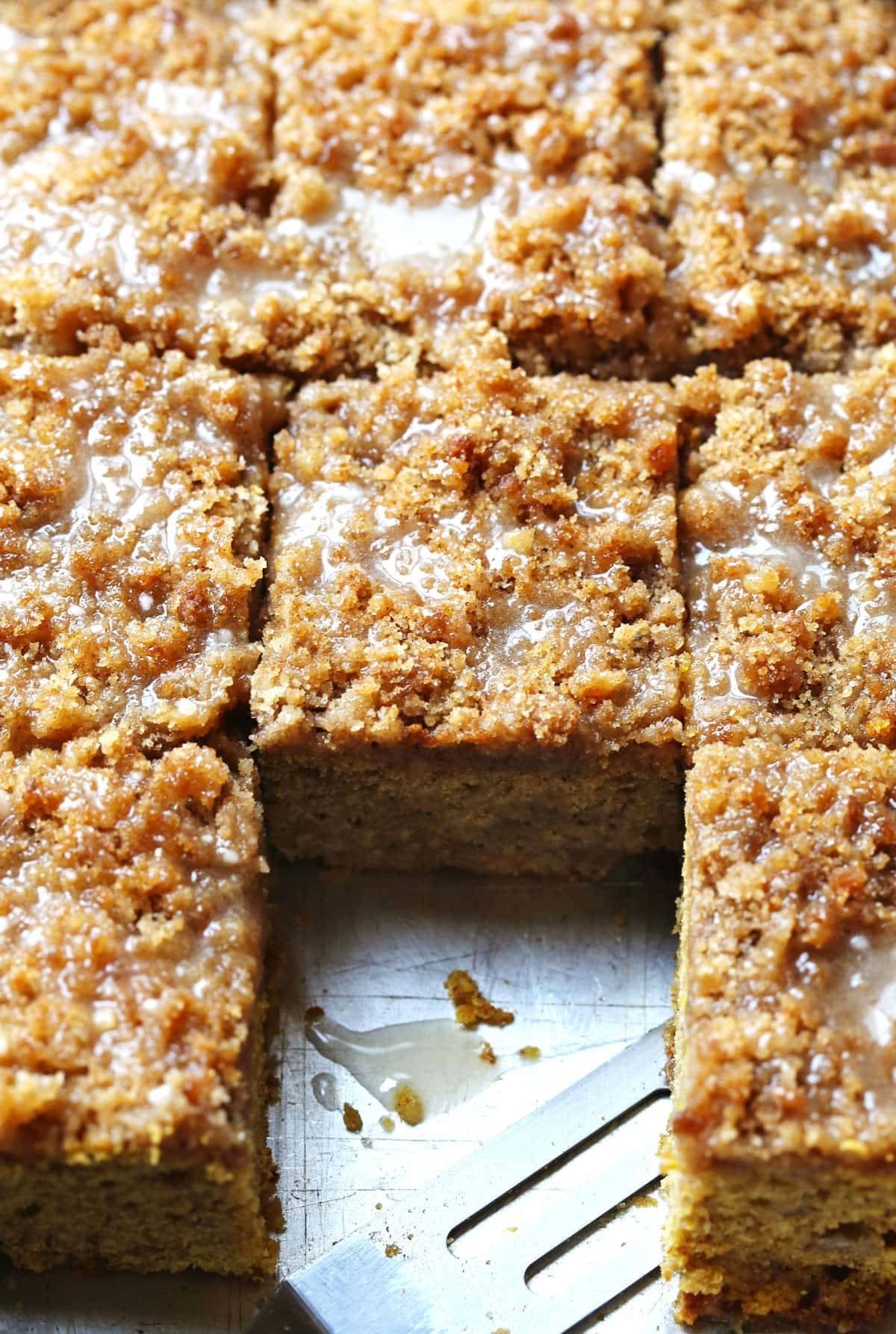 Cinnamon Streusel Pumpkin Coffee Cake with Maple Glaze cut into pieces.